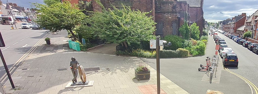 Behind the shelter in the middle of a roundabout